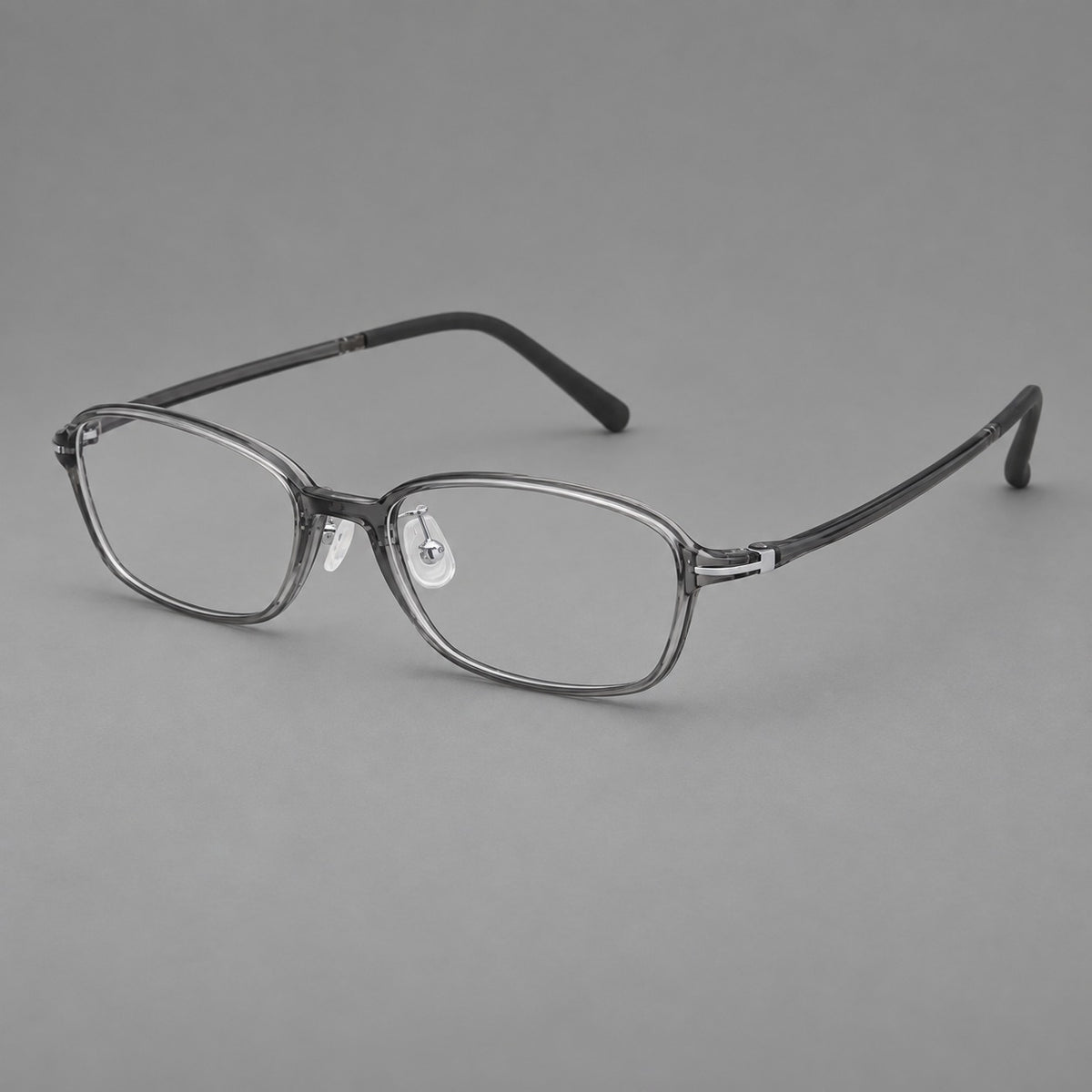 Soft oval plastic eyeglasses with a narrow bridge and gently rounded outer corners in Medium Grey, three quarter view