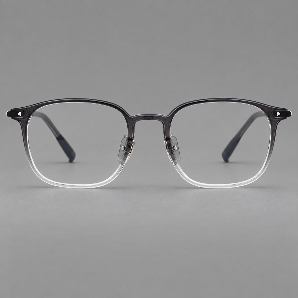 Retro square plastic eyeglasses with a curved bridge and triangular corner details in Ink Grey Gradient, front view