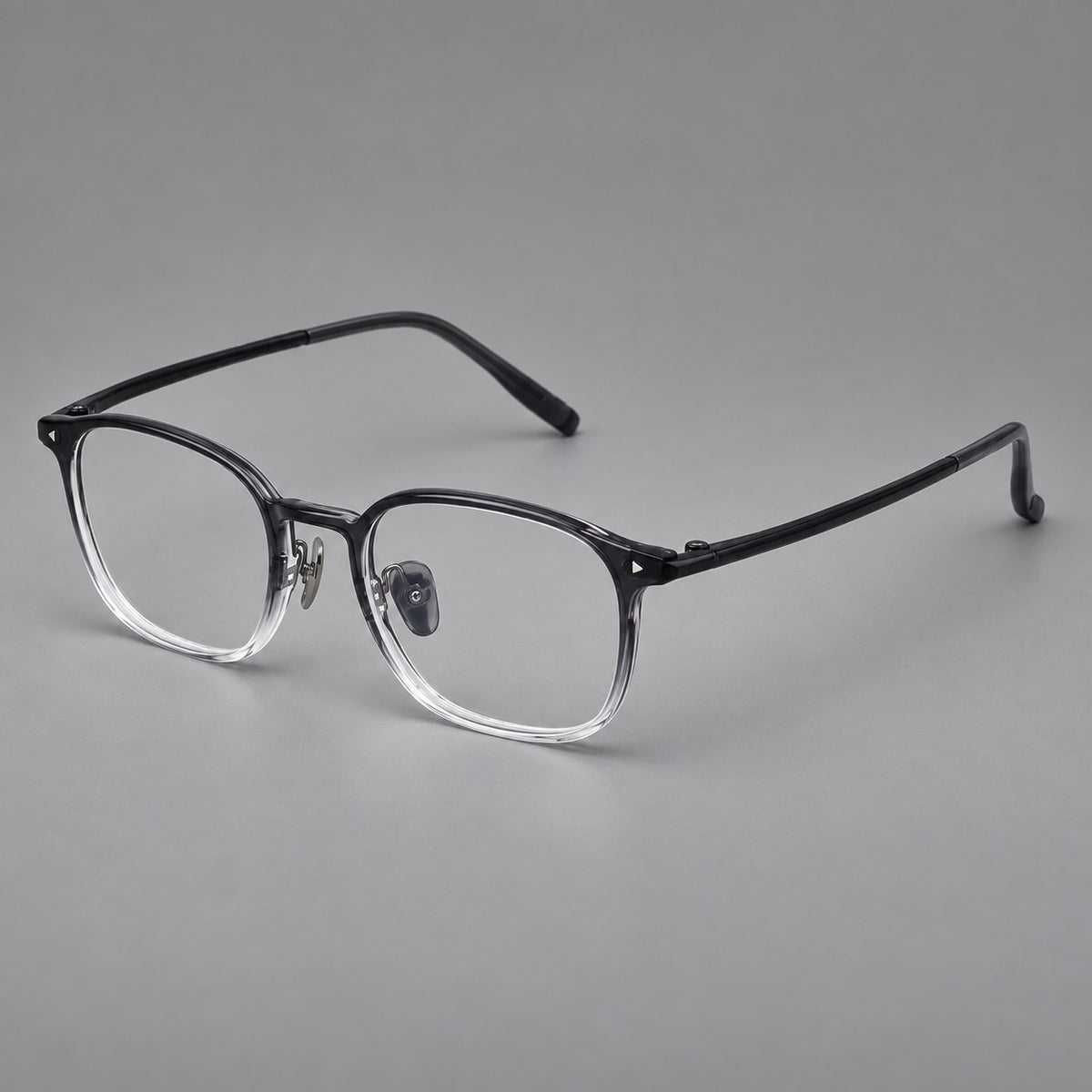 Retro square plastic eyeglasses with a curved bridge and triangular corner details in Ink Grey Gradient, three quarter view