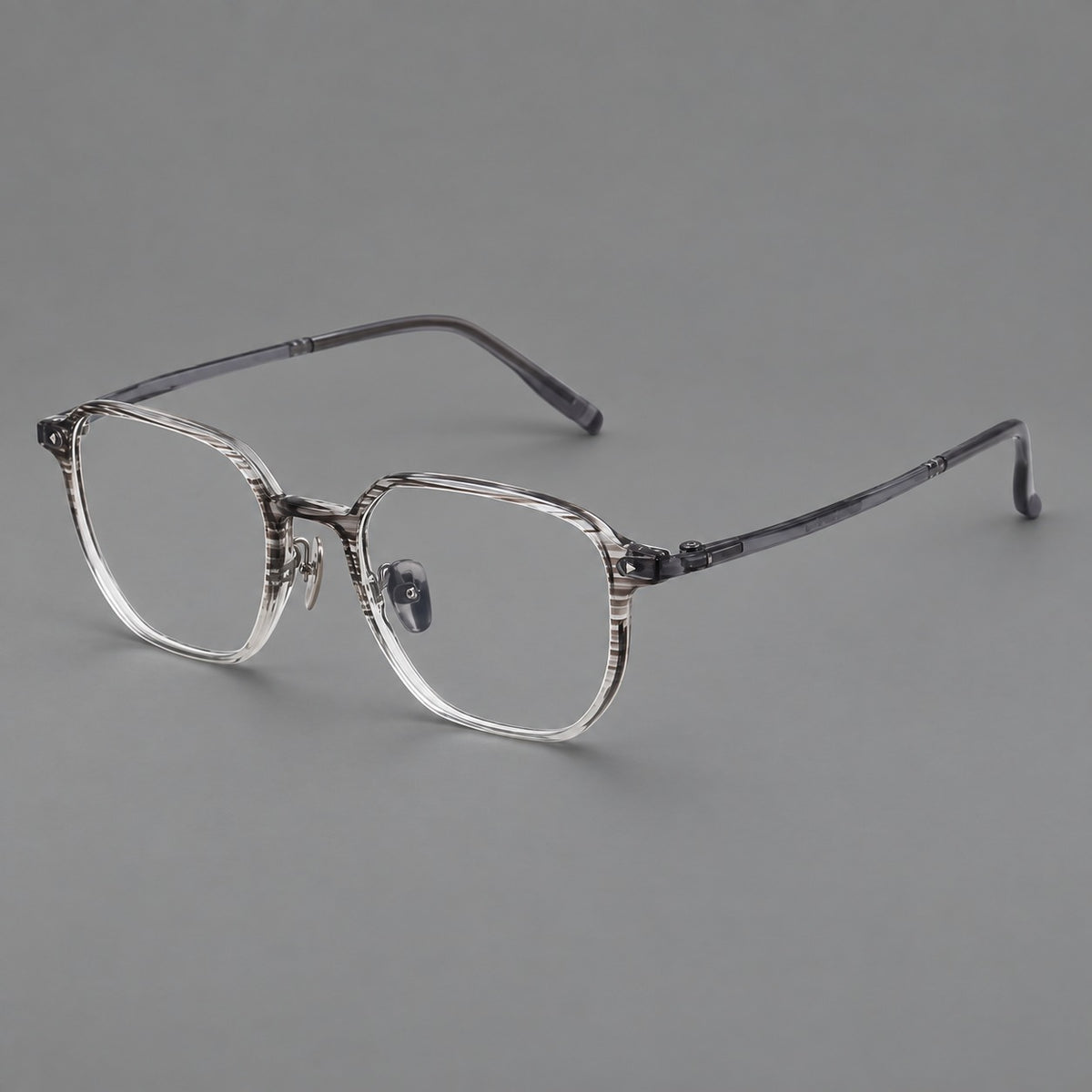 Soft square plastic eyeglasses with rounded lower rims and a broad curved bridge in Striped Grey Gradient, three quarter view