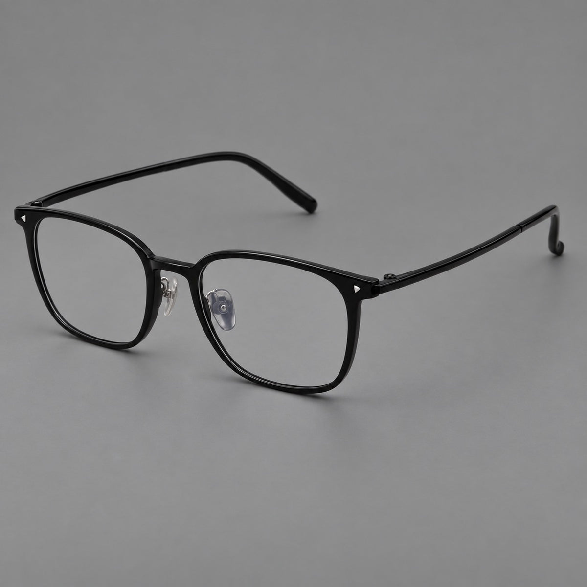 Classic soft square plastic eyeglasses with a gently curved browline and corner studs in Glossy Black, three quarter view
