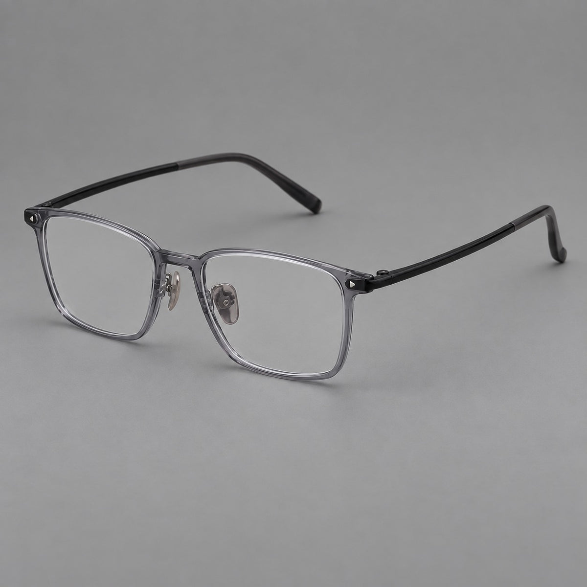 Clean rectangular plastic eyeglasses with flat lower rims and pointed corner details in Ink Grey, three quarter view