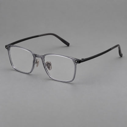 Clean rectangular plastic eyeglasses with flat lower rims and pointed corner details in Ink Grey, three quarter view front view