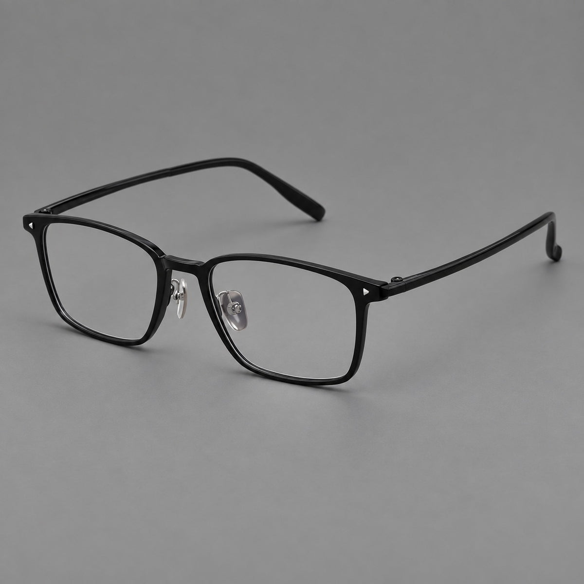 Clean rectangular plastic eyeglasses with flat lower rims and pointed corner details in Glossy Black, three quarter view