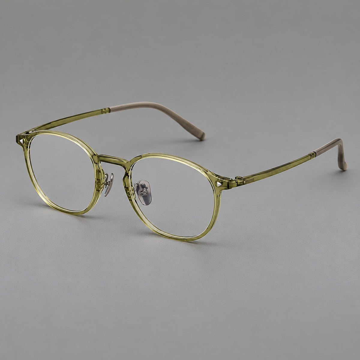 Vintage round plastic eyeglasses with a curved bridge and subtle triangular accents in Light Green, three quarter view