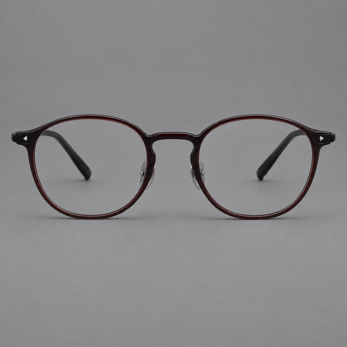 Vintage round plastic eyeglasses with a curved bridge and subtle triangular accents in Deep Wine Red, front view