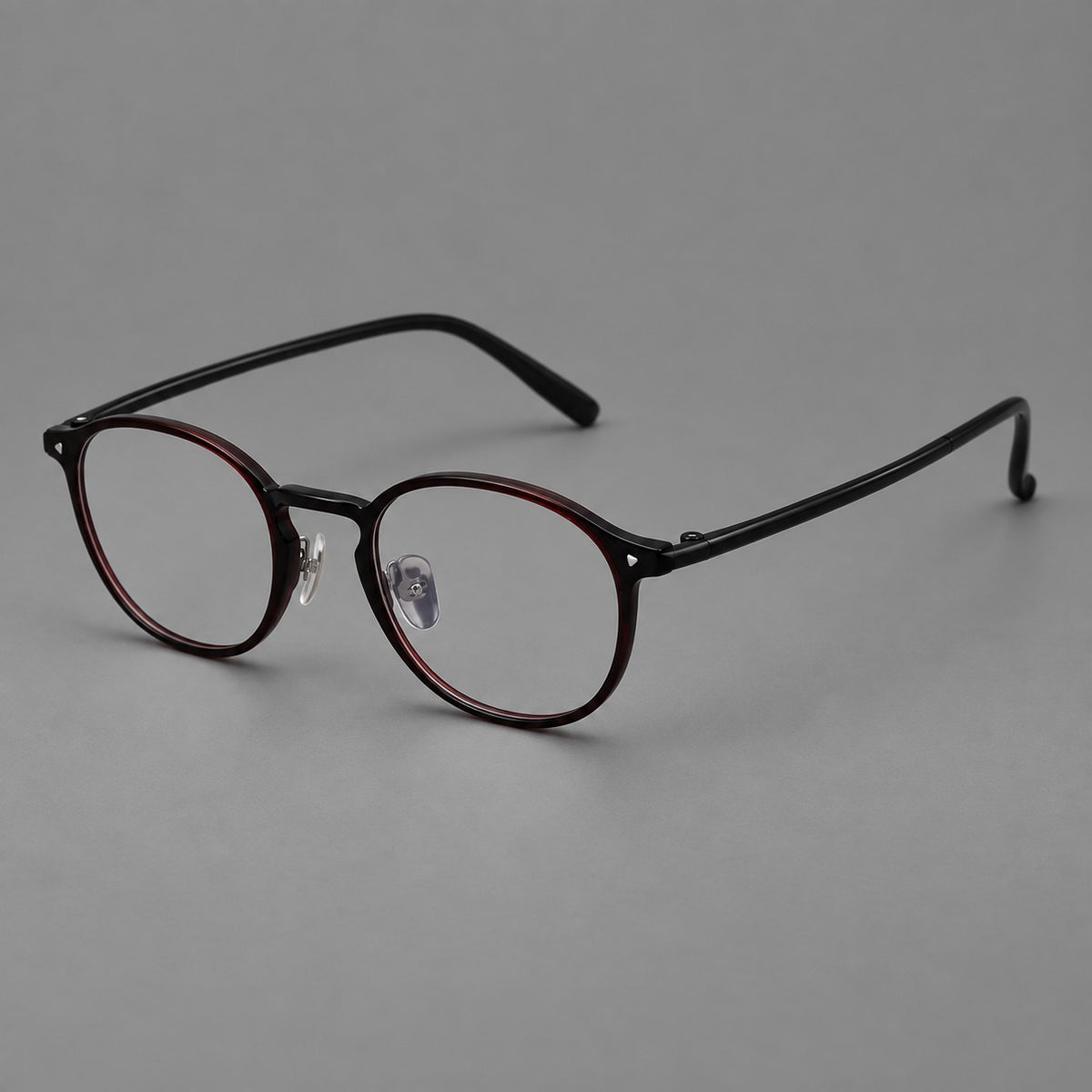 Vintage round plastic eyeglasses with a curved bridge and subtle triangular accents in Deep Wine Red, three quarter view
