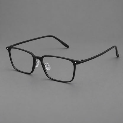 Wide rectangular plastic eyeglasses with an angular browline and slender rims in Matte Black, three quarter view lens detail