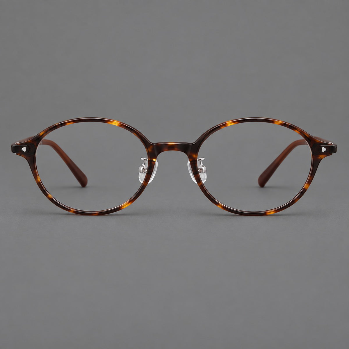 Retro round plastic eyeglasses with softly lifted corners and a sculpted bridge in Tortoiseshell, front view