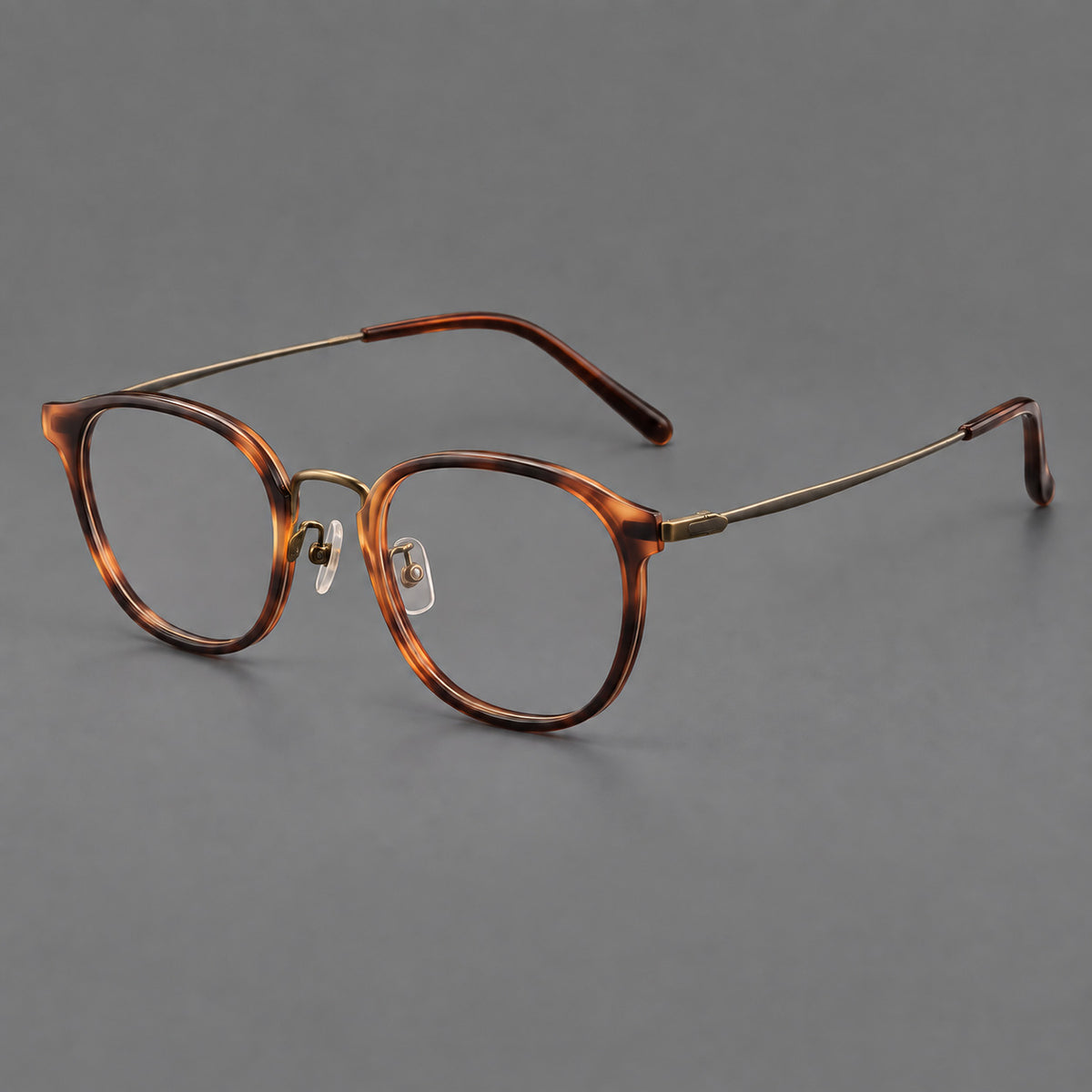 Retro soft square eyeglasses in acetate and titanium with a curved bridge and slender temples in Amber Tortoiseshell / Antique Gold, three quarter view