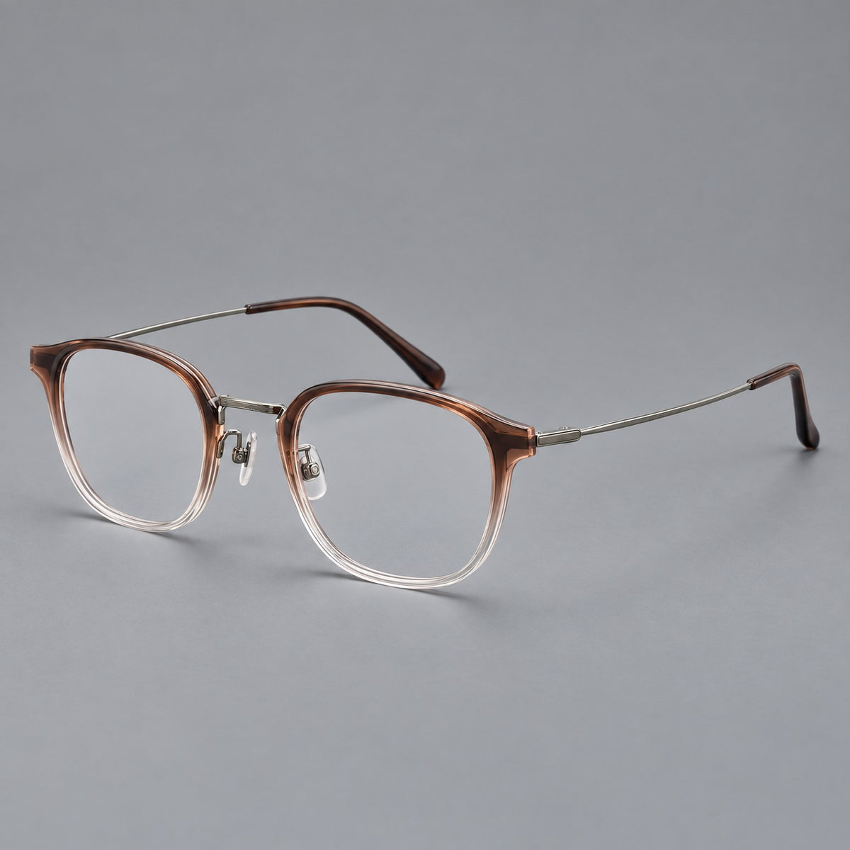 Retro soft square eyeglasses in acetate and titanium with a curved bridge and slender temples in Brown Gradient / Light Gunmetal, three quarter view