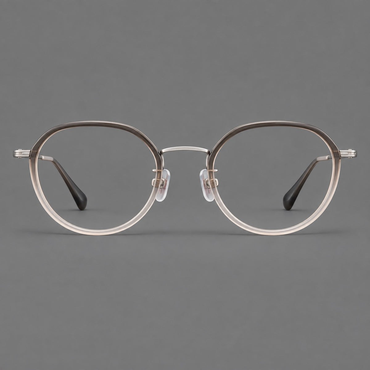 Rounded eyeglasses in acetate and titanium with gently arched brows and engraved metal temples in Mist Grey Gradient / Silver, front view