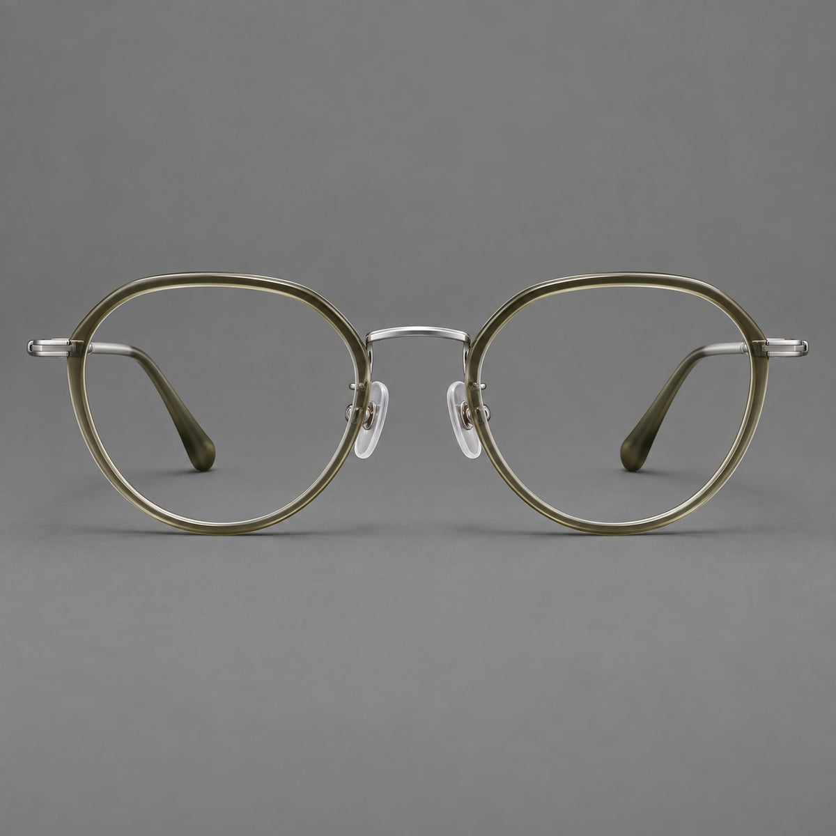 Rounded eyeglasses in acetate and titanium with gently arched brows and engraved metal temples in Grey Green / Silver, front view