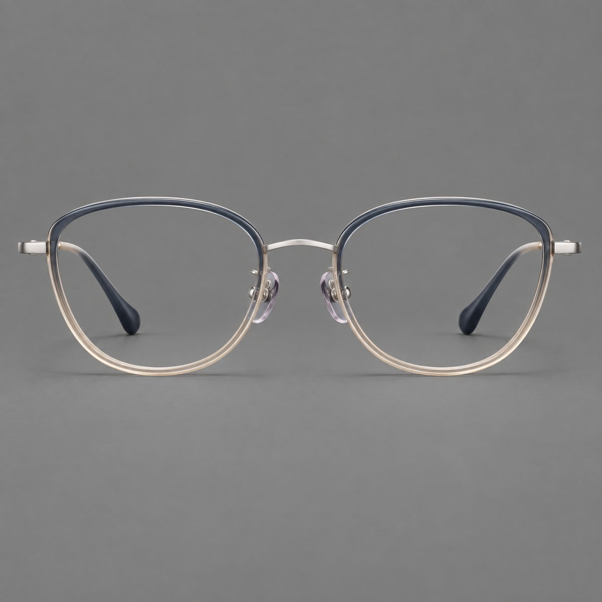 Upswept eyeglasses in acetate and titanium with softly rounded rims and tapered metal temples in Blue Tea Gradient / Gunmetal, front view