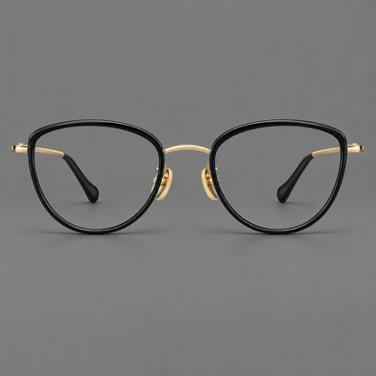 Upswept eyeglasses in acetate and titanium with softly rounded rims and tapered metal temples in Black / Gold, front view additional product view