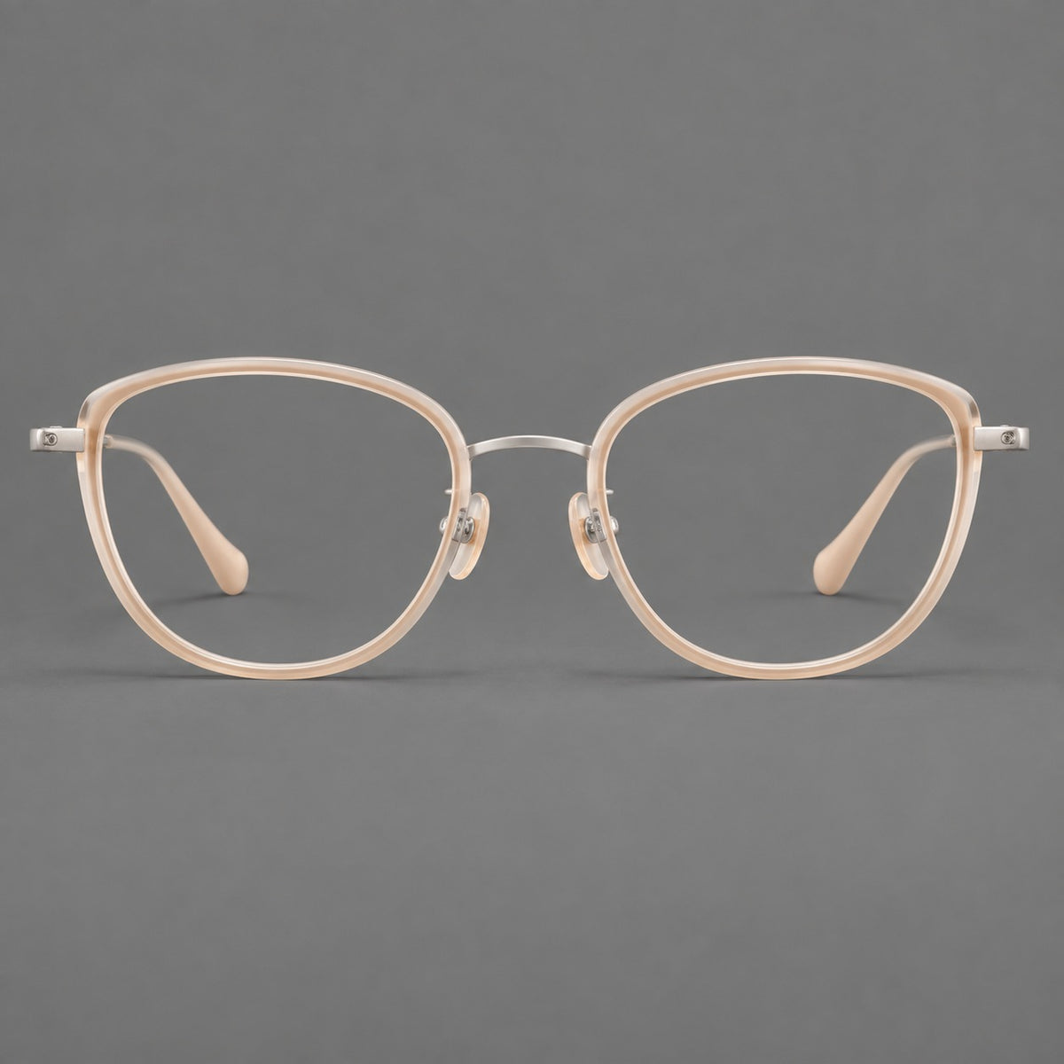 Upswept eyeglasses in acetate and titanium with softly rounded rims and tapered metal temples in Nude Pink / Silver, front view