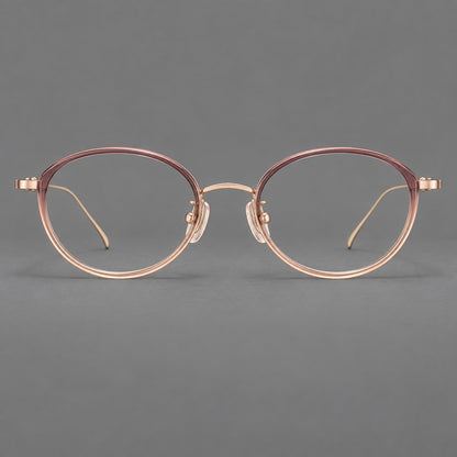 Round eyeglasses in acetate and titanium with a slim curved bridge and fine metal temples in Pink Tea Gradient / Rose Gold, front view frame detail