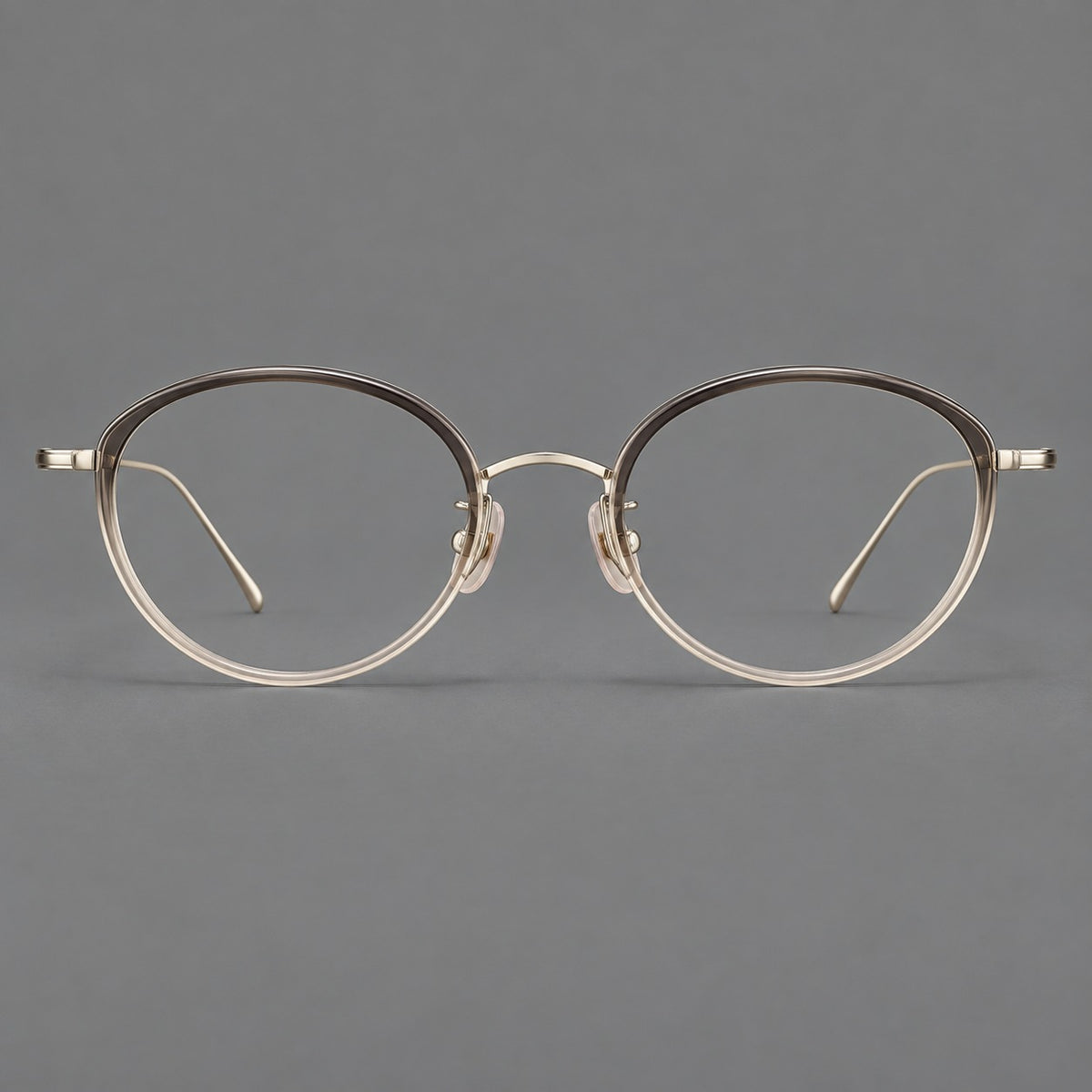 Round eyeglasses in acetate and titanium with a slim curved bridge and fine metal temples in Grey Tea Gradient / Gold, front view