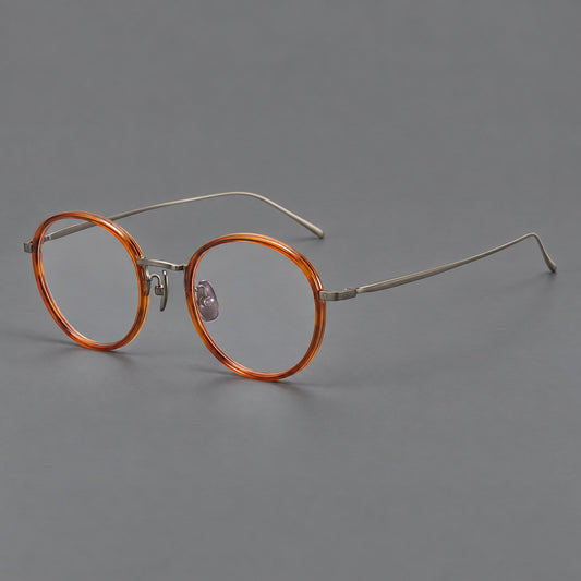 Classic round eyeglasses in acetate and titanium with slim rims and textured metal temples in Tea Brown / Gunmetal, three quarter view