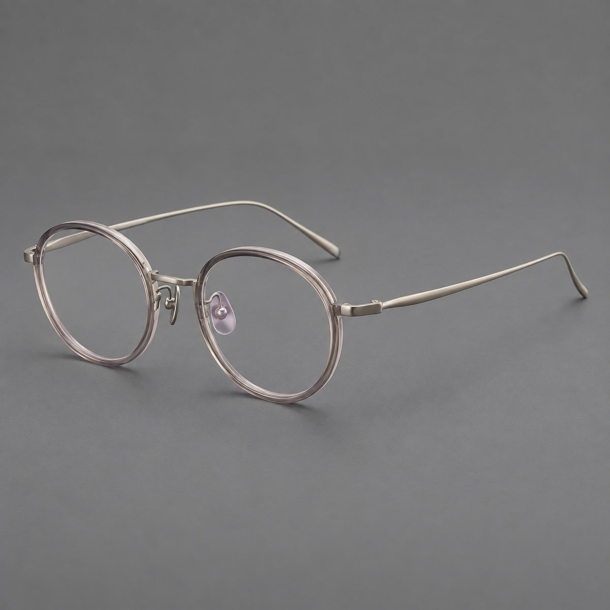 Classic round eyeglasses in acetate and titanium with slim rims and textured metal temples in Grey Pink Gradient / Gunmetal, three quarter view