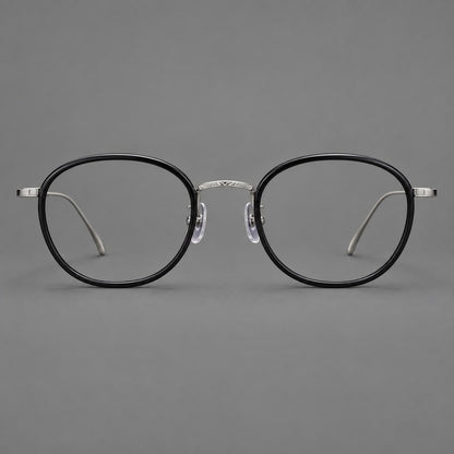 Vintage round eyeglasses in acetate and titanium with an engraved bridge and slender temples in Glossy Black / Gunmetal, front view additional product view