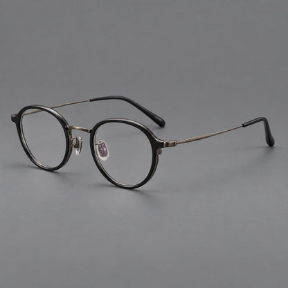 Softly rounded eyeglasses in acetate and titanium with a curved bridge and engraved temples in Matte Black / Antique Copper, three quarter view additional product view