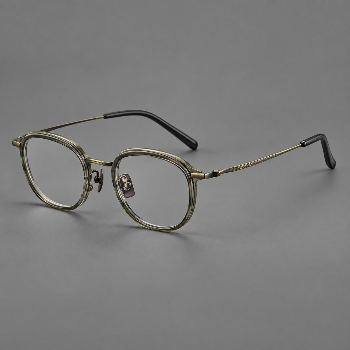 Soft square eyeglasses in acetate and titanium with rounded corners and decorative metal temples in Ice Grey Tortoiseshell / Antique Gold, three quarter view