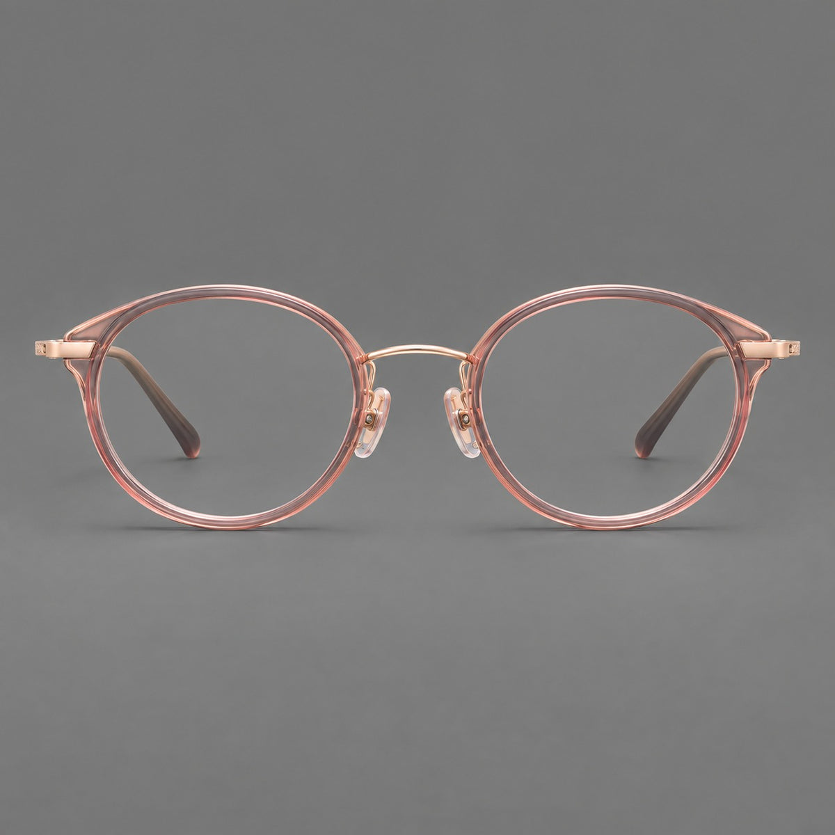 Retro panto eyeglasses in acetate and titanium with an arched bridge and engraved metal temples in Patterned Pink / Rose Gold, front view