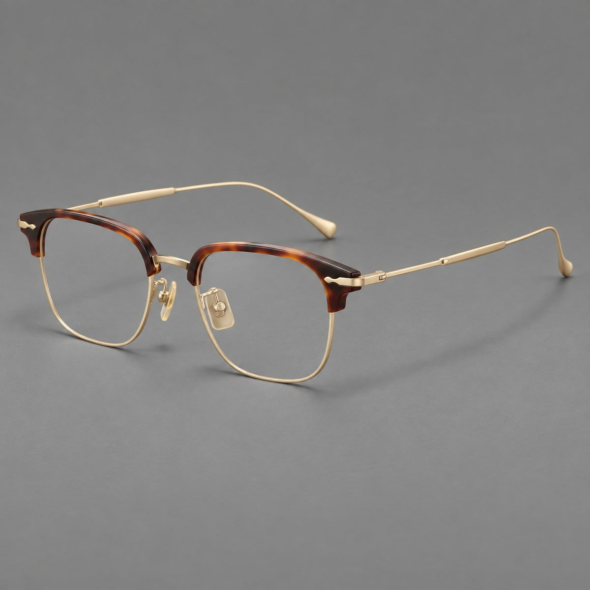 Browline eyeglasses in acetate and titanium with slim metal lower rims and decorative corners in Tortoiseshell / Gold, three quarter view