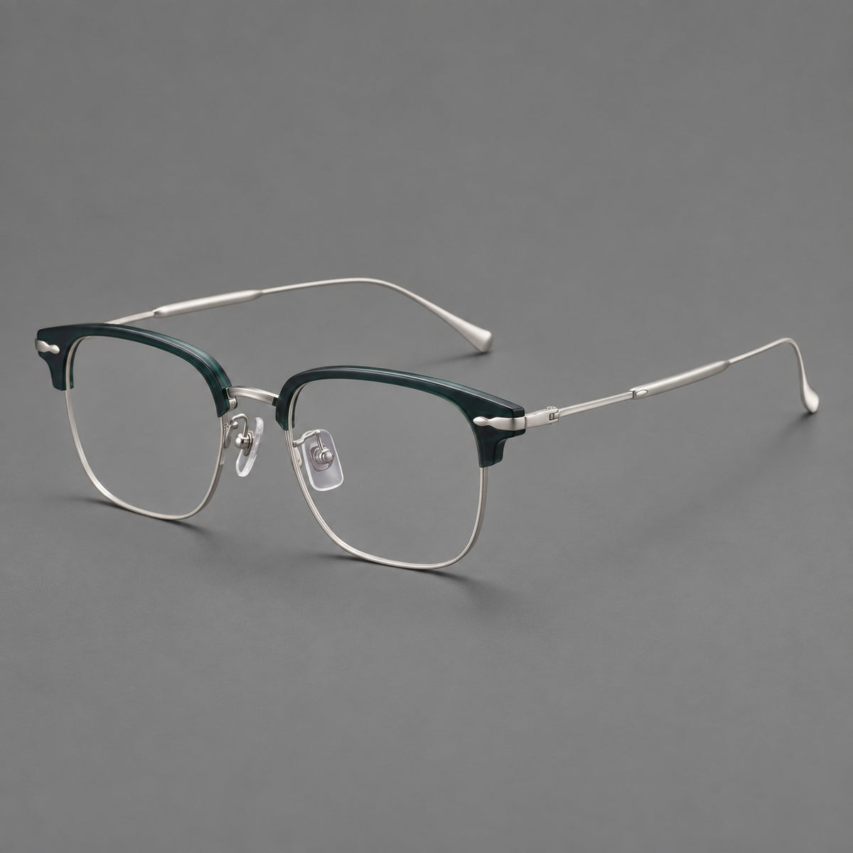 Browline eyeglasses in acetate and titanium with slim metal lower rims and decorative corners in Peacock Blue / Silver, three quarter view