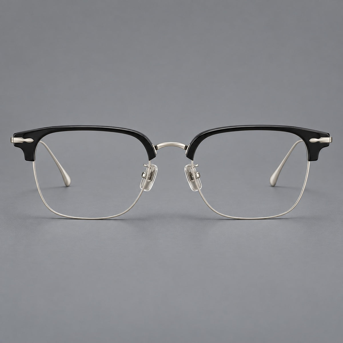 Browline eyeglasses in acetate and titanium with slim metal lower rims and decorative corners in Glossy Black / Silver, front view