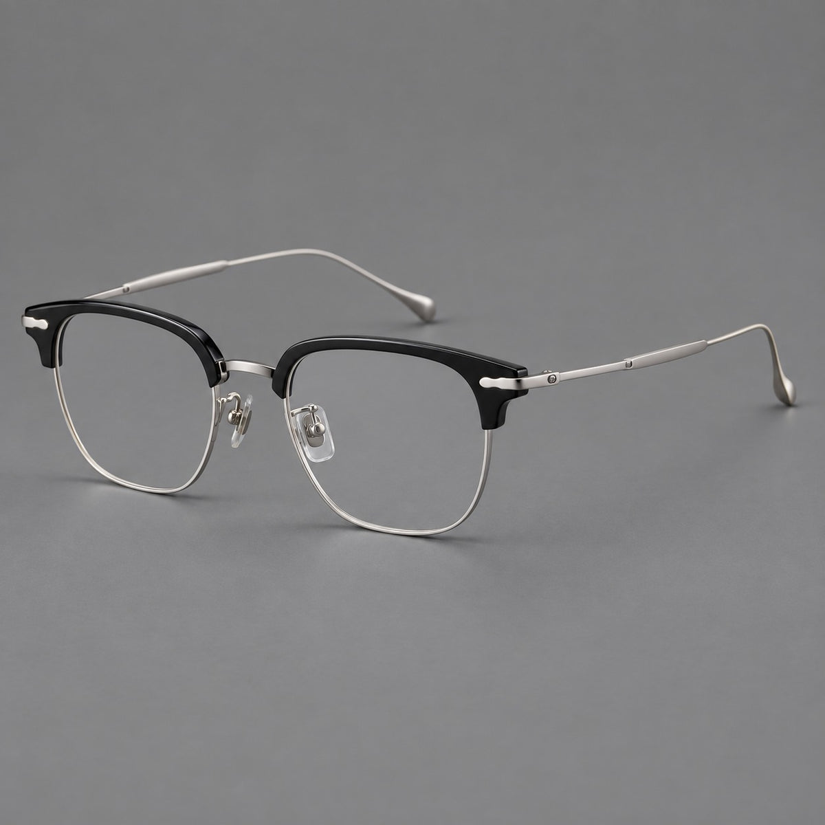 Browline eyeglasses in acetate and titanium with slim metal lower rims and decorative corners in Glossy Black / Silver, three quarter view