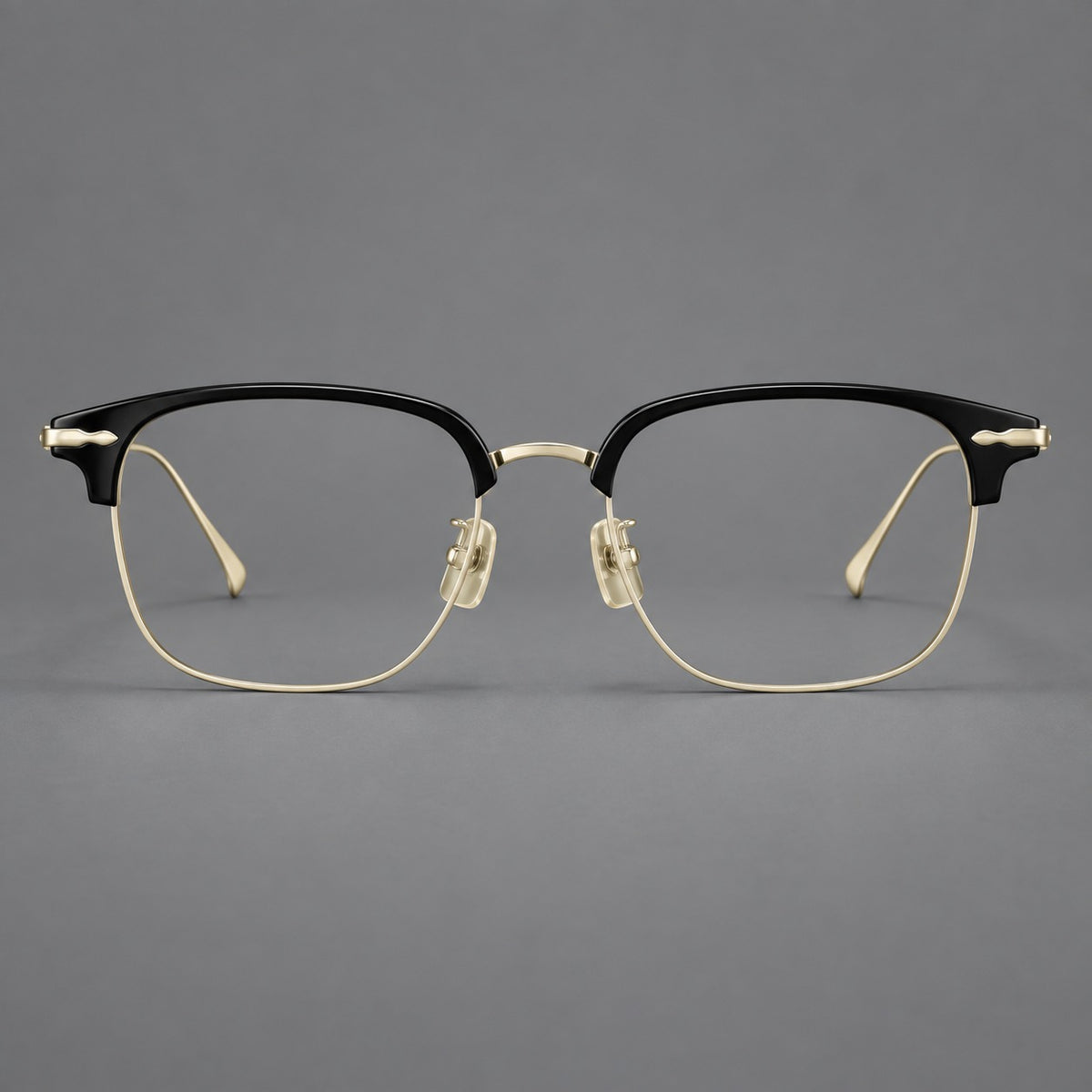 Browline eyeglasses in acetate and titanium with slim metal lower rims and decorative corners in Glossy Black / Gold, front view