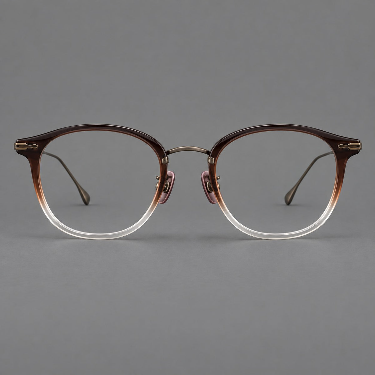 Panto eyeglasses in acetate and titanium with curved brows and decorative metal corner accents in Tea Brown Gradient / Antique Bronze, front view