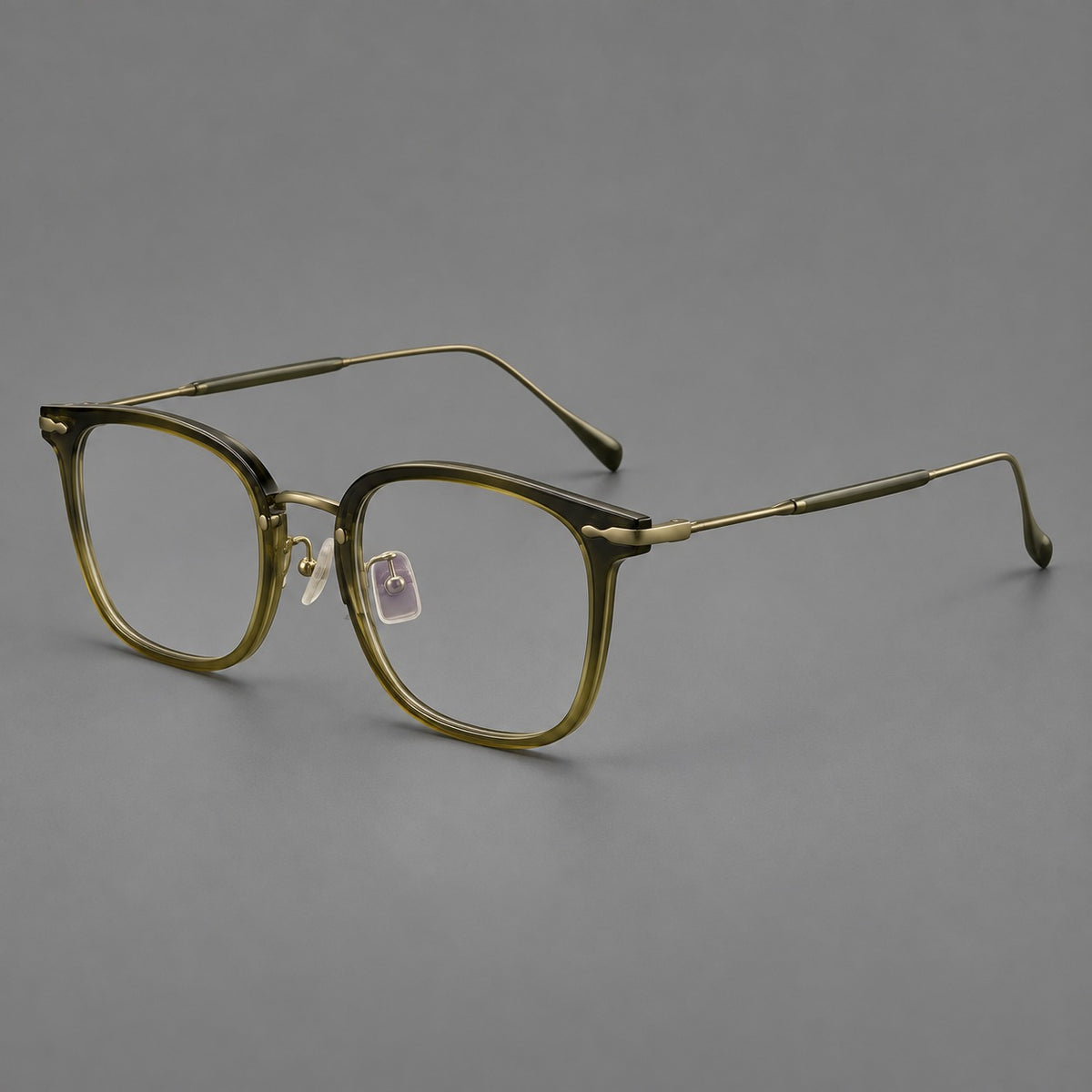 Retro square eyeglasses in acetate and titanium with rounded edges and sculpted corner accents in Green / Antique Bronze, three quarter view