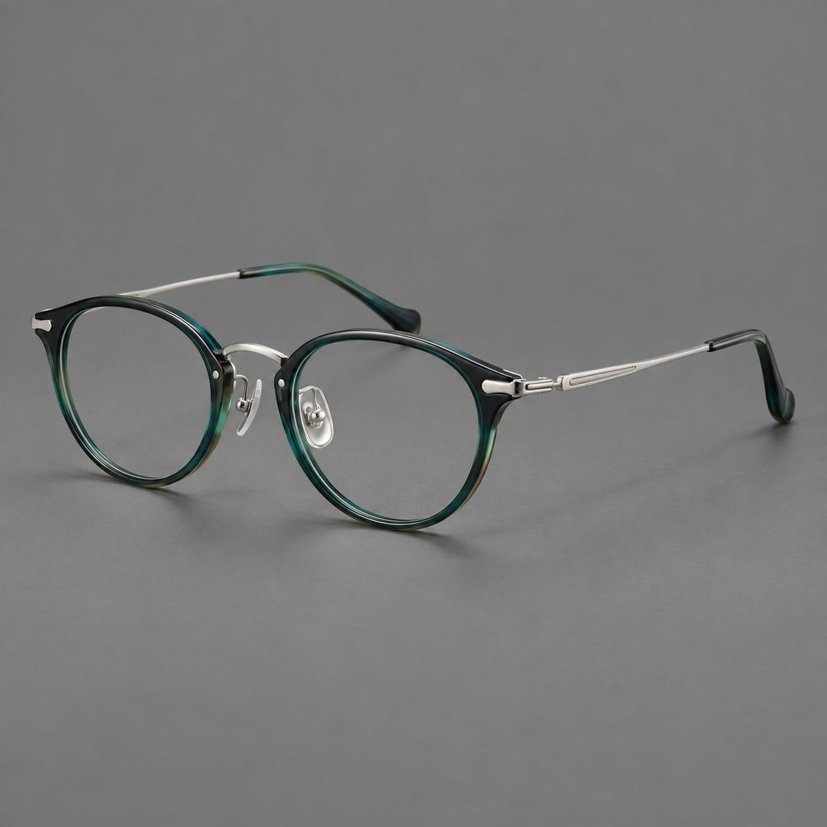 Vintage panto eyeglasses in acetate and titanium with raised brows and textured metal temples in Peacock Blue / Silver, three quarter view