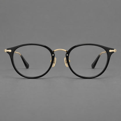 Vintage panto eyeglasses in acetate and titanium with raised brows and textured metal temples in Glossy Black / Gold, front view temple detail