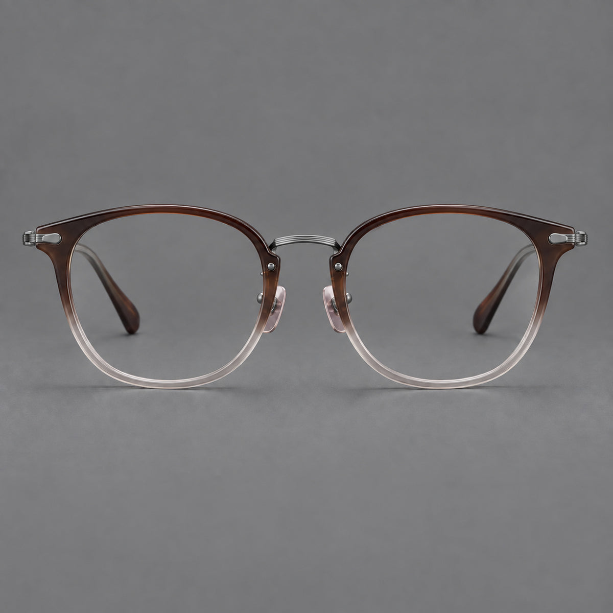 Classic soft square eyeglasses in acetate and titanium with engraved temples and corner accents in Tea Brown Gradient / Dark Grey, front view