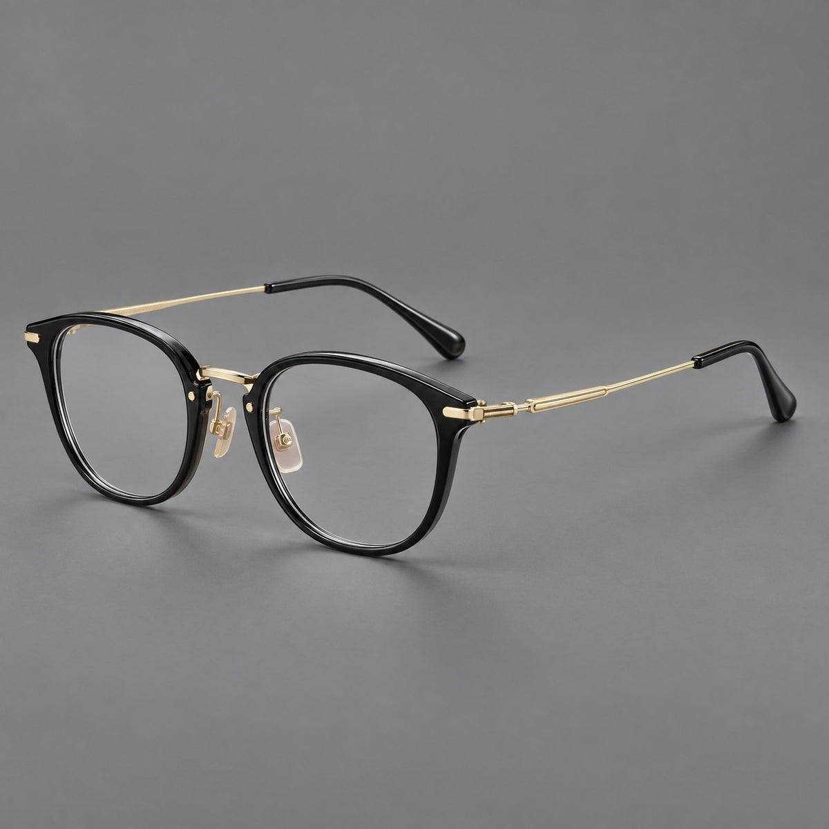 Classic soft square eyeglasses in acetate and titanium with engraved temples and corner accents in Glossy Black / Gold, three quarter view