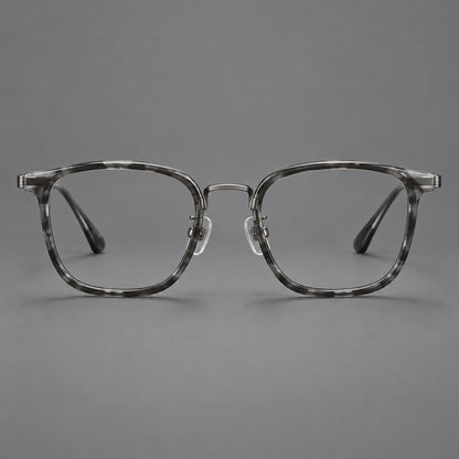 Soft square eyeglasses in acetate and titanium with wide upper corners and fine metal temples in Marbled Grey / Gunmetal, front view frame detail