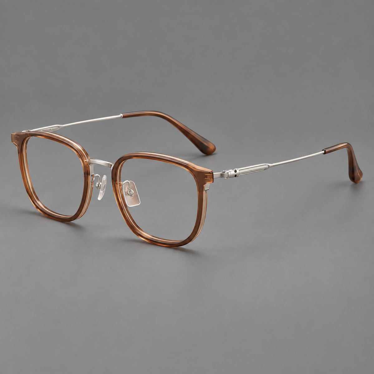 Soft square eyeglasses in acetate and titanium with wide upper corners and fine metal temples in Clear Tea / Silver, three quarter view