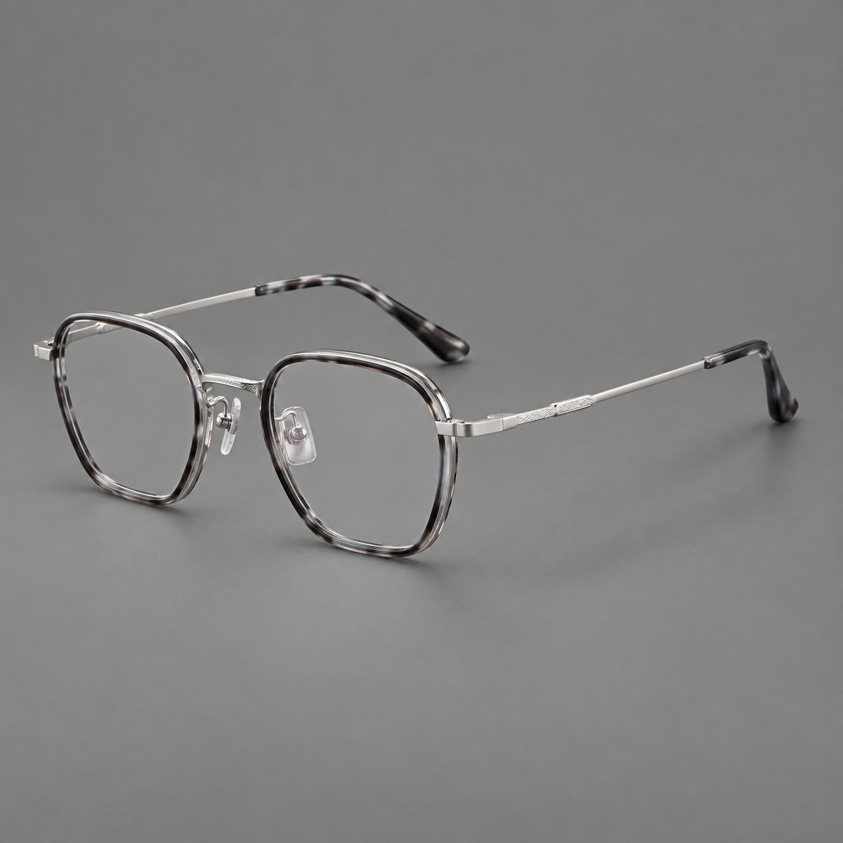 Soft square eyeglasses in acetate and titanium with slim rims and a finely engraved metal bridge in Grey Tortoiseshell / Silver, three quarter view