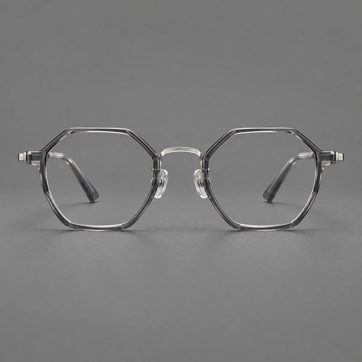 Geometric eyeglasses in acetate and titanium with octagonal rims and a textured metal bridge in Clear Mist Grey / Silver, front view