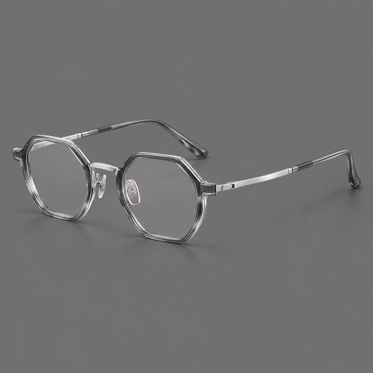 Geometric eyeglasses in acetate and titanium with octagonal rims and a textured metal bridge in Clear Mist Grey / Silver, three quarter view