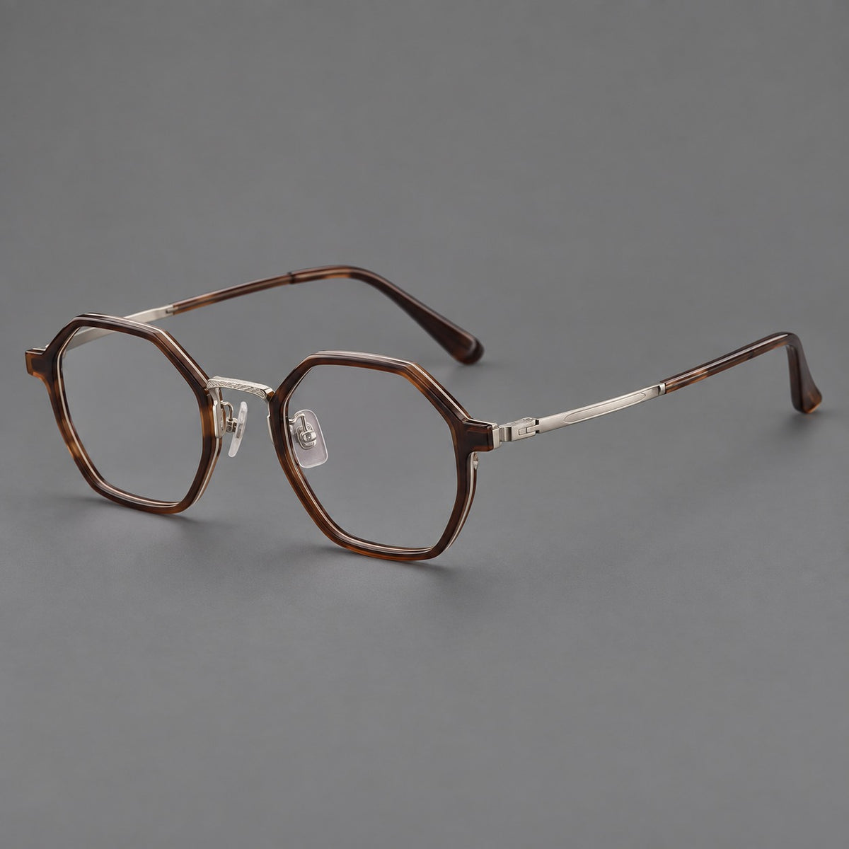 Geometric eyeglasses in acetate and titanium with octagonal rims and a textured metal bridge in Warm Tea Brown / Light Gunmetal, three quarter view