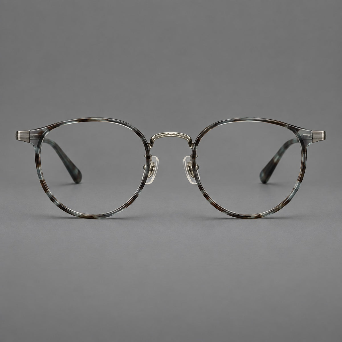 Round eyeglasses in acetate and titanium with widened outer corners and slender metal temples in Green Grey Tortoiseshell / Gunmetal, front view