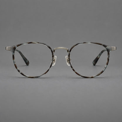 Round eyeglasses in acetate and titanium with widened outer corners and slender metal temples in Green Grey Tortoiseshell / Gunmetal, front view frame detail