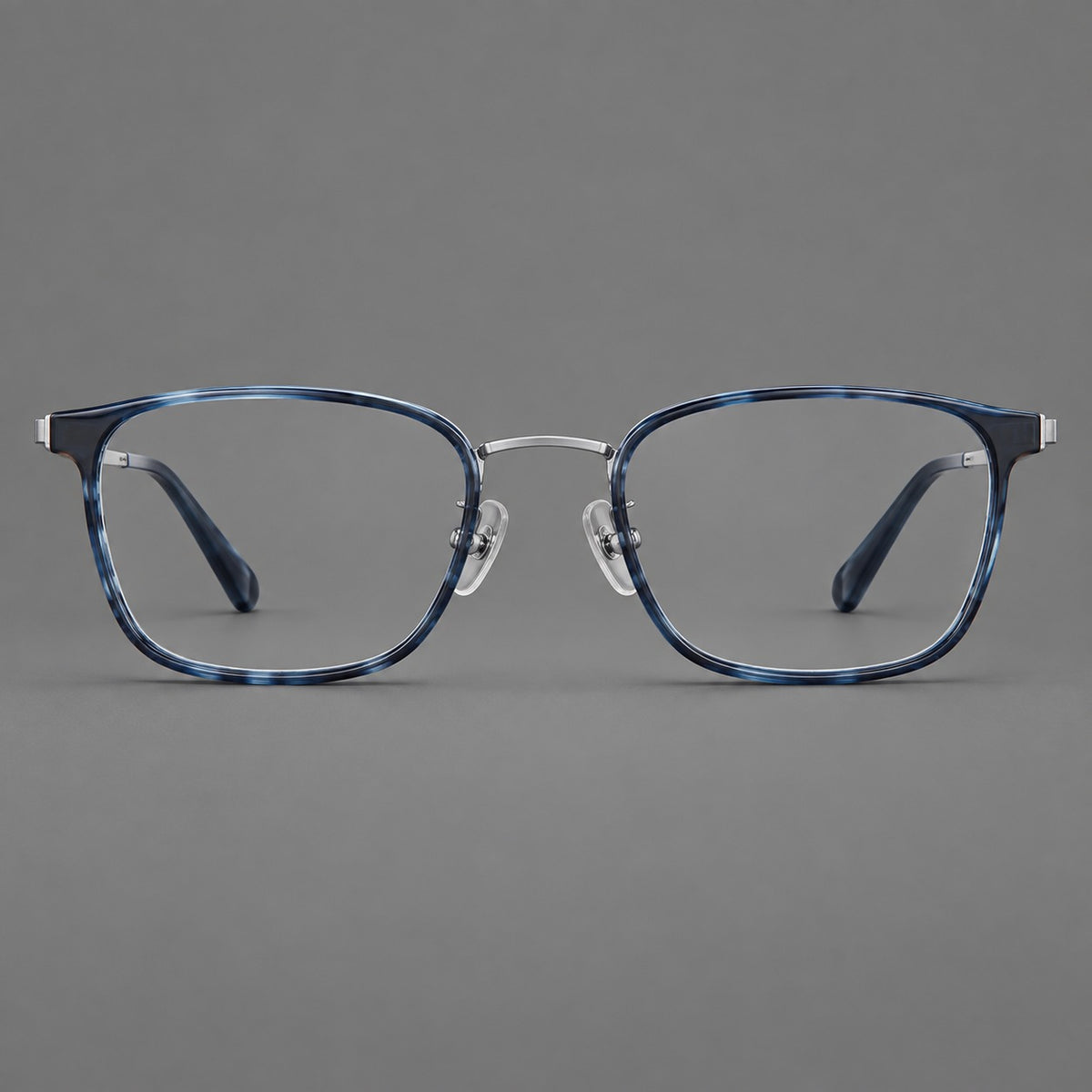Rounded rectangular eyeglasses in acetate and titanium with bold corners and engraved metal temples in Blue / Gunmetal, front view