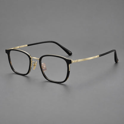 Rounded rectangular eyeglasses in acetate and titanium with bold corners and engraved metal temples in Glossy Black / Gold, three quarter view lens detail