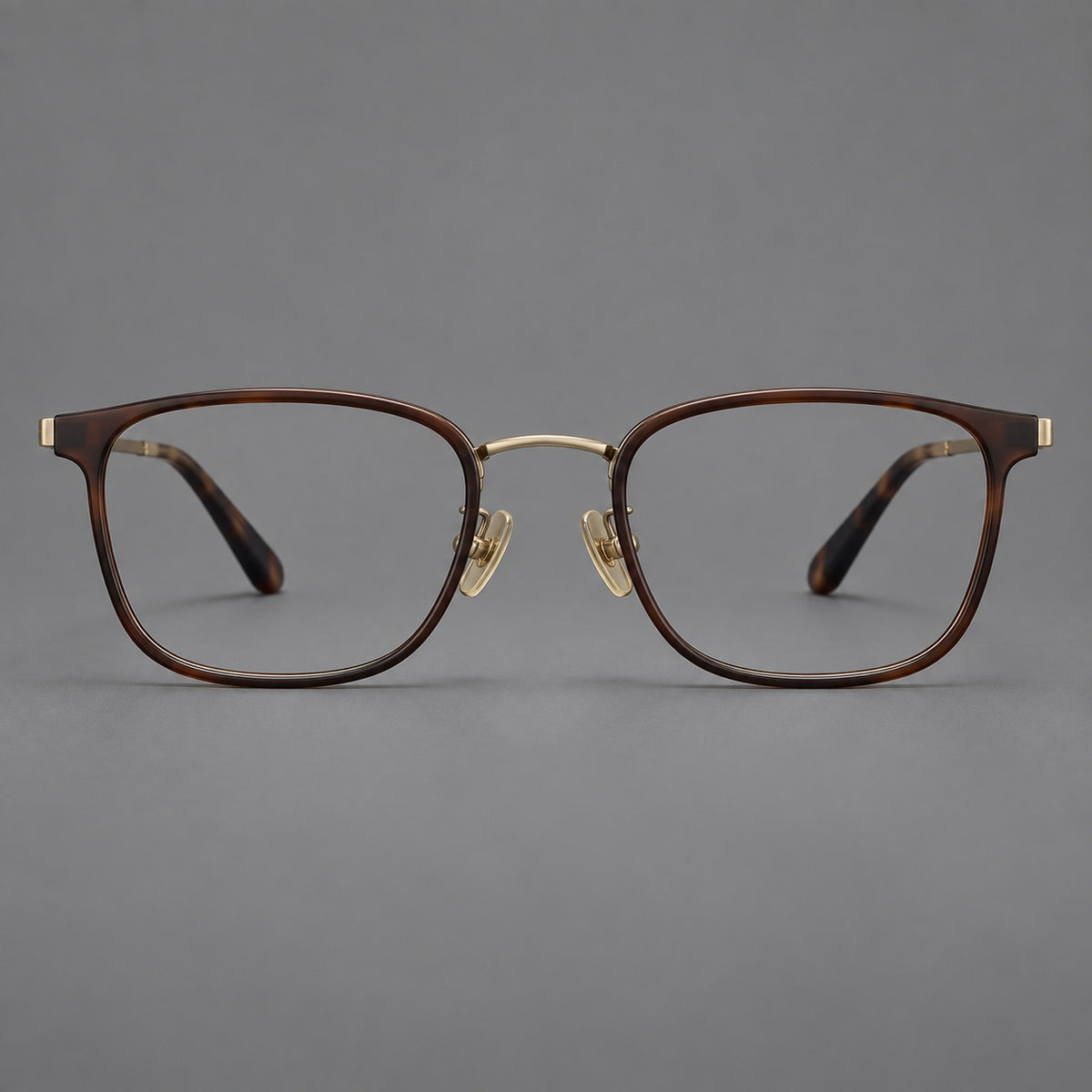 Rounded rectangular eyeglasses in acetate and titanium with bold corners and engraved metal temples in Coffee Brown / Antique Bronze, front view